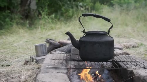 Old Kettle Standing on a Tourist Campfire in Nature