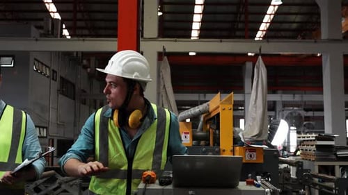 Two specialists inspect commercial, Wear safety uniform and White helmet