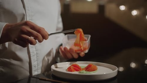 Chef Cooking Delicatessen Meal With Salmon On Stage Of Opera House Closeup View Of Plate And Hands