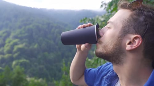 Young man in the forest watching nature scenery.