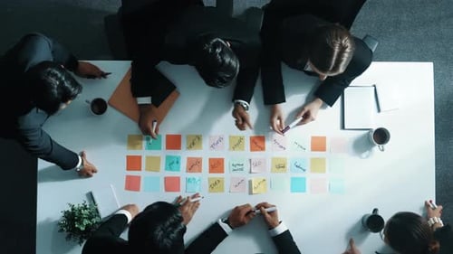 Business Team Brainstorming with Sticky Notes in Meeting Room