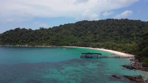 Jetty at Beach on Besar Perhentian island. Dramatic aerial view flight drone