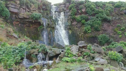 Aerial drone footage of a tall rocky waterfall in the Yorkshire Dales, Pennies. Moorland scene of a