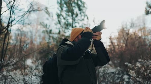 Photographer Takes Pictures in Winter Landscape