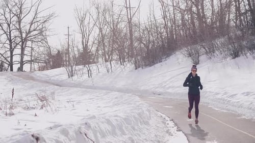 Female Runner Jogging on Road Action