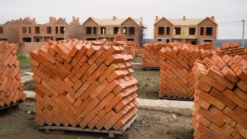 Stacks of Red Bricks at Residential Construction Site