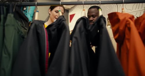 Woman and Friend Shop for Jackets at Store