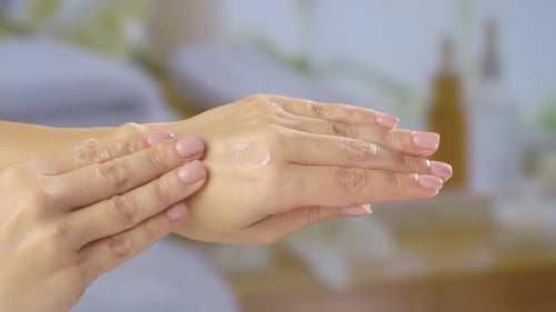 Applying Moisturizing Cream on Hands