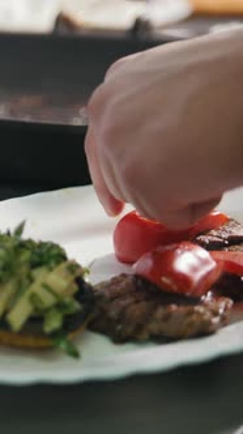 El chef sirve bistec en el plato en el restaurante