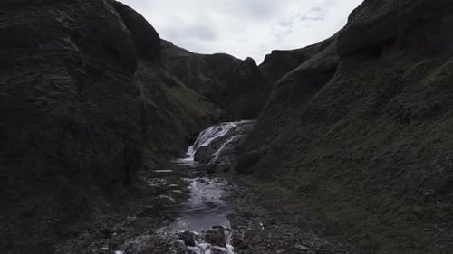 Aerial view of people jumping at Stjornarfoss waterfall, Iceland