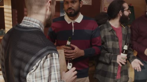 Friends Socializing and Drinking Beer Indoors