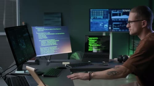 Young Male Programmer Getting Back to Work on Program Coding in Office