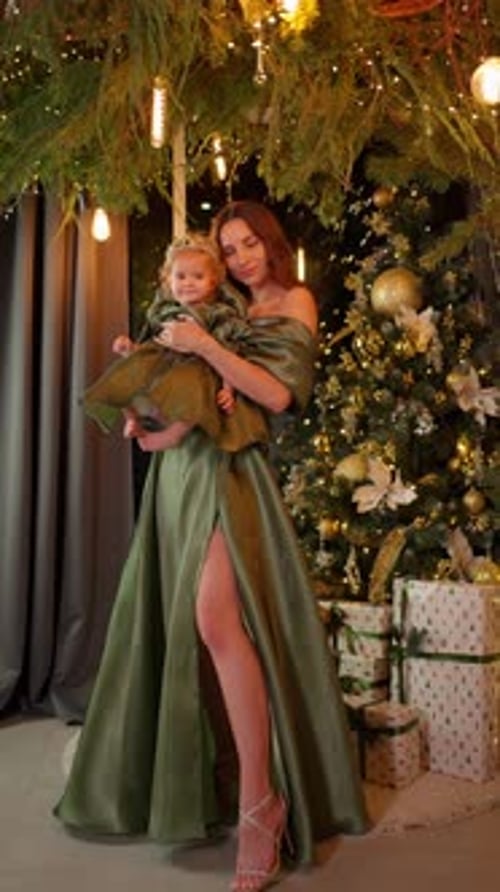 Mother Holding Little Daughter Under Christmas Tree Family New Year Concept