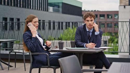 Business Partners Calling Restaurant Terrace Focused Businessman Businesswoman