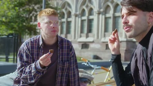 Male Friends Eating Snacks and Speaking Outdoors on Campus
