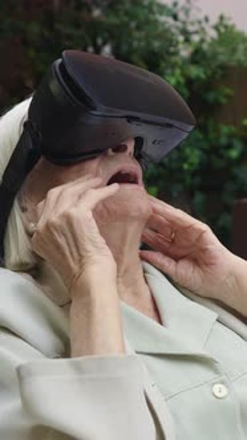 Ältere Frau erkundet virtuelle Realität in Zeitlupe