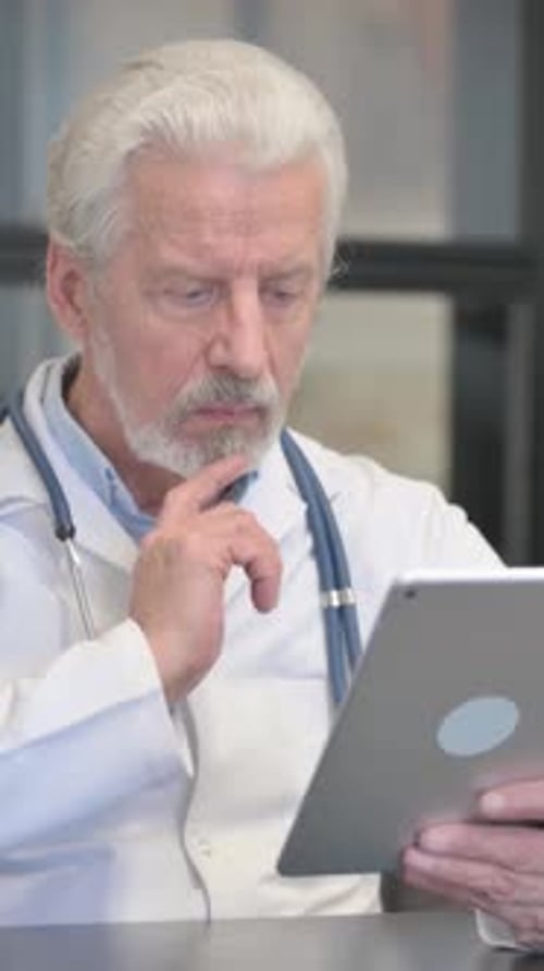 Mature Doctor Uses Tablet for Medical Research
