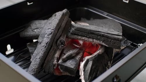 Charcoal Burning Brightly in a Black Metal Grill