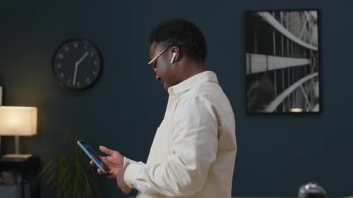 Young Adult Chatting on Phone Indoors