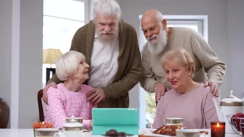 Seniors Enjoying Video Call on Tablet Together