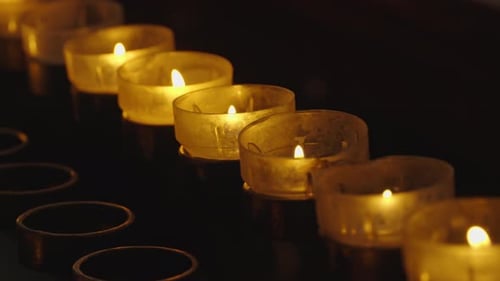 A lot of burning candles in temple. Concept thanksgiving, halloween, christmas. Flame burning