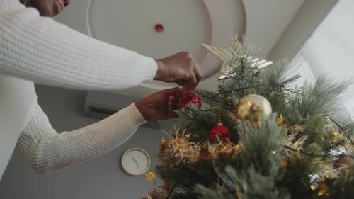 Decorating Christmas Tree with Festive Red Ornaments