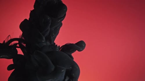 Black Ink Flowing in Red Water Background