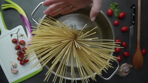 Adding Spaghetti to Pot of Water Overhead Shot