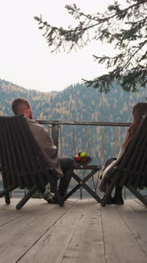 Friends Rest on Wooden Terrace of Glamping