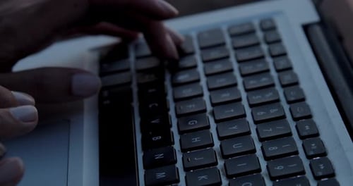 Girl hands typing on laptop, close up