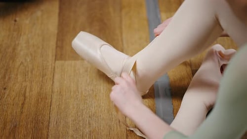 Close Up Professional Ballet School for Children Ballerinas Put on Point Shoes While Sitting on the