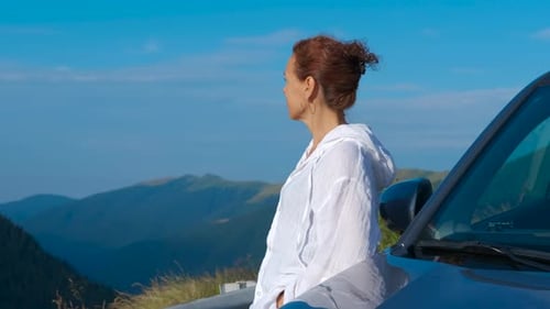 Woman Looking at Mountain View from Car