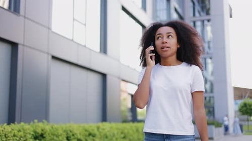 Frustrated Woman Using Mobile Phone in City