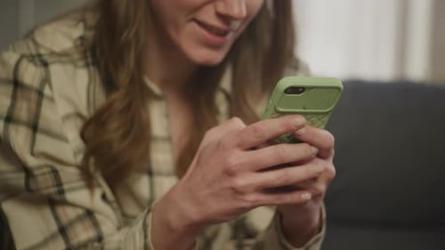 Woman Using Smartphone with Green Case