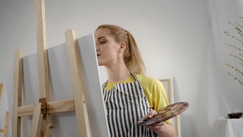 Young Adult Female Artist Drawing Picture By Oil Dyes in Art Studio Portrait Professional Painter or