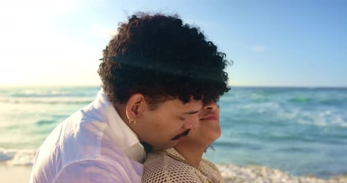 Couple, relax and beach with hug or kiss for sunset, love or bonding for holiday