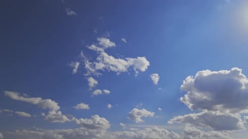 Billowing White Clouds Flowing in a Blue Sky