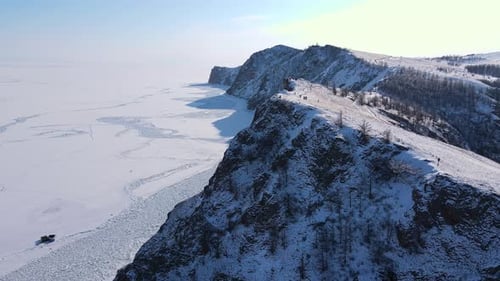 Capturing a Stunning Winter Landscape an Aerial View Shows Frozen Cliffs Under a Clear Sky