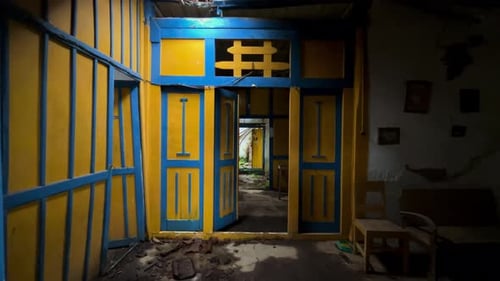 Dilapidated Building Interior with Blue and Yellow Walls