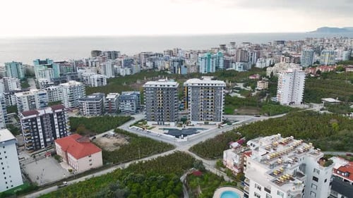 Aerial Video Modern Building Facade Set Against a Cloudy Sky for a Scenic Urban View