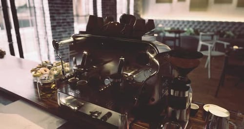 Elegant Coffee Machine in a Modern Cafe Setting with Pastries on Display