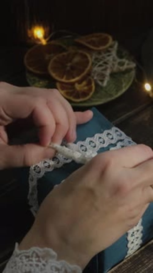 Vertical Video Female Hands Decorating Christmas Gift Bow with Lace Ribbon