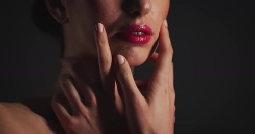 Woman with Makeup Touches Face