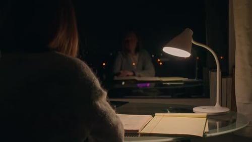 Adult Writing at Desk Late at Night