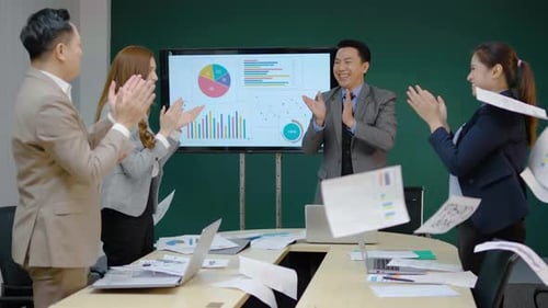 Excited Business Team Celebrates Success in Meeting