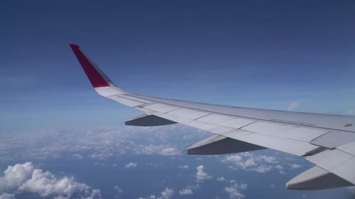 Clouds and sky as seen through window of an aircraft