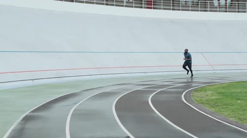 African American Sportsman Starting to Run on Sports Track. Athletic Man In