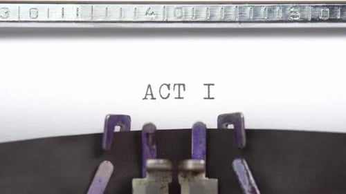 Act one word closeup being typing and centered on a sheet of paper on old vintage typewriter