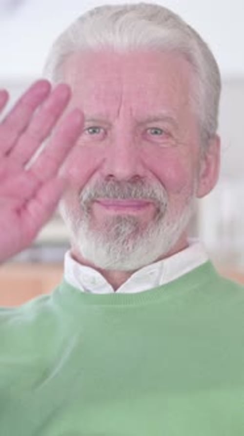 Senior Man Waving and Smiling at the Camera