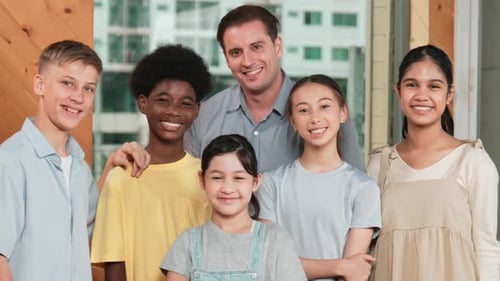 Smiling Group of Children with Adult Male Indoors